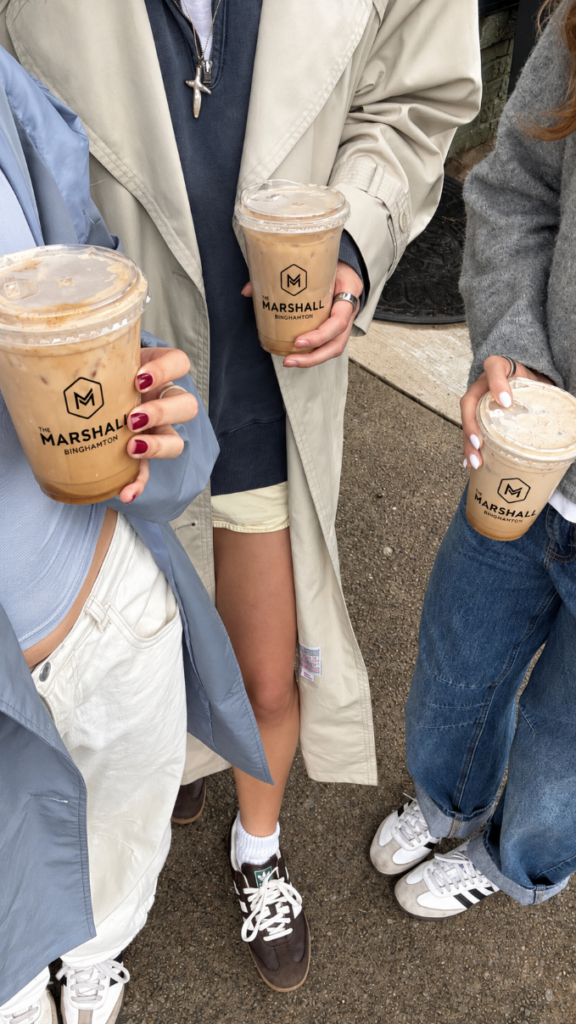 Friends holding branded iced-coffee cups