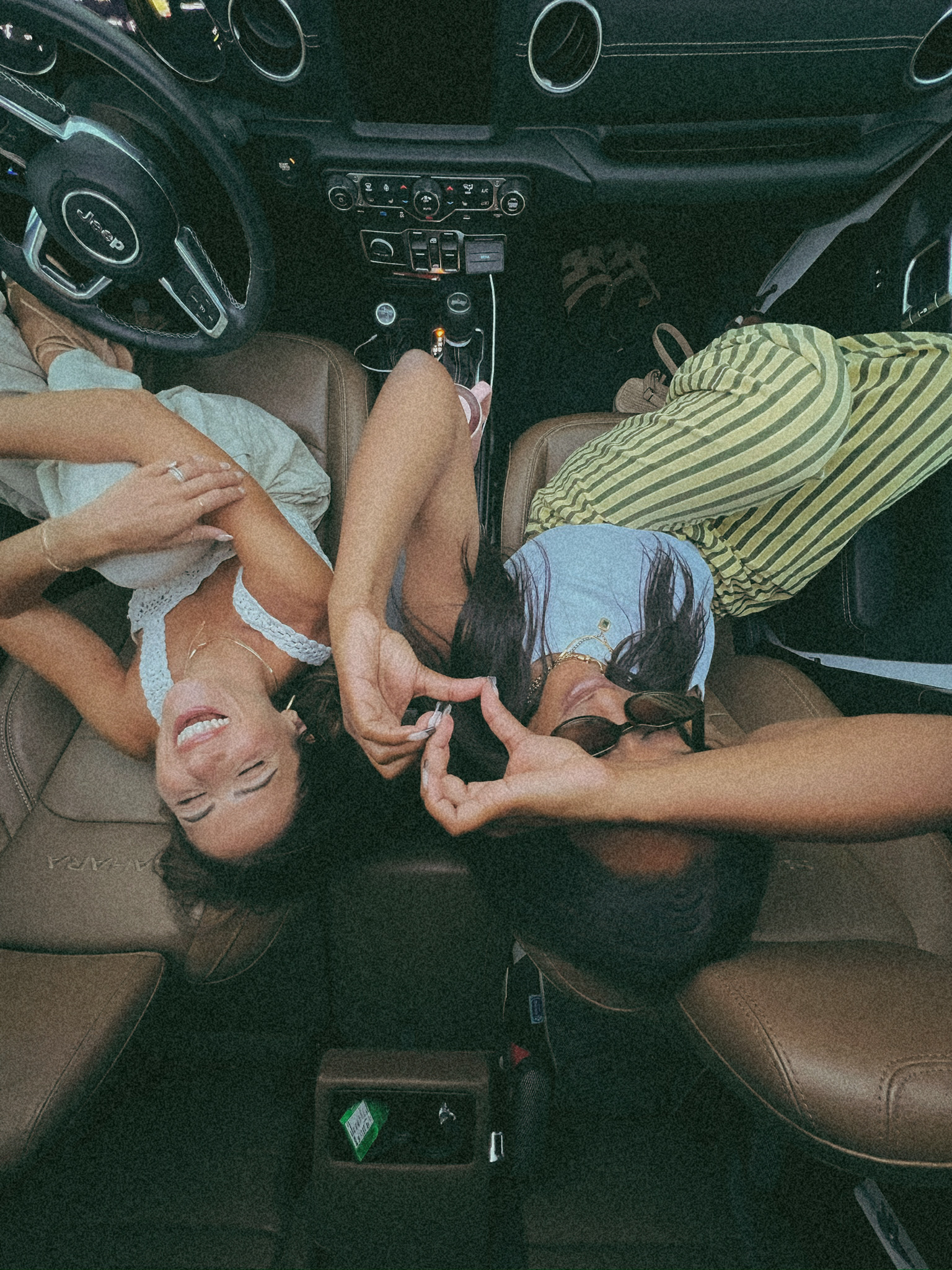 Friends laughing in a Jeep